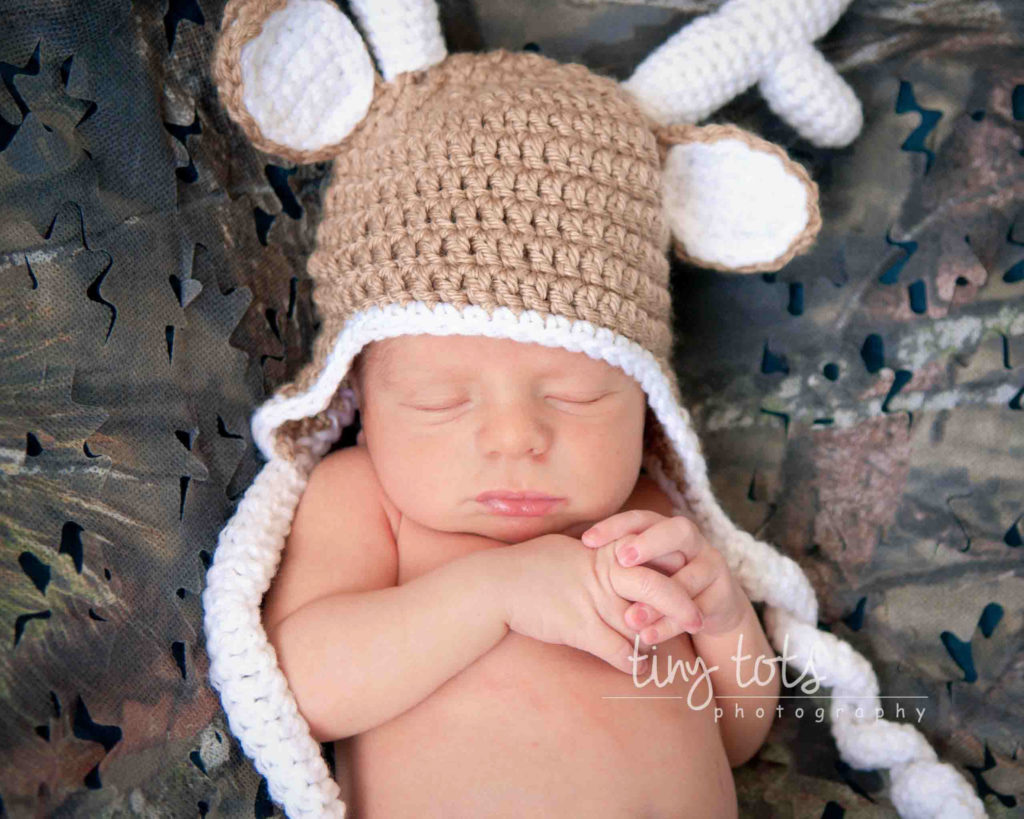 a newborn photo session with baby as a deer