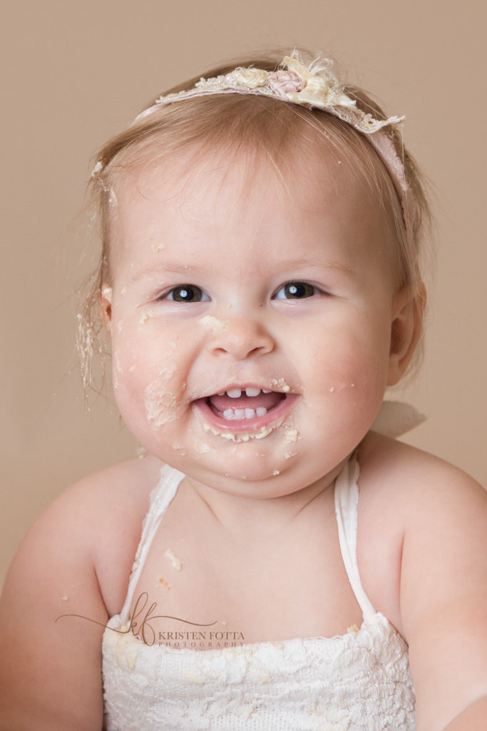 happy baby with cake on face